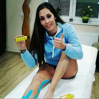 Female athlete massaging her knee with Muay cream
