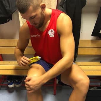 Athlete holds Thai cream in hand